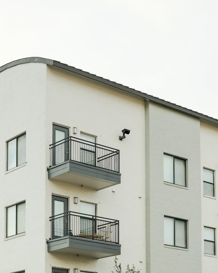 Contemporary apartment featuring sleek balconies and large windows.